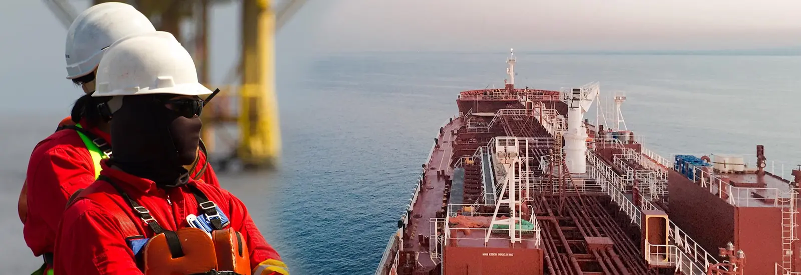 A seafarer in a hard hat and coveralls on deck, with a tanker alongside