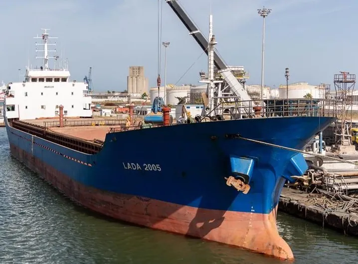 Lada 2005 alongside a berth, with a shore crane over her hold