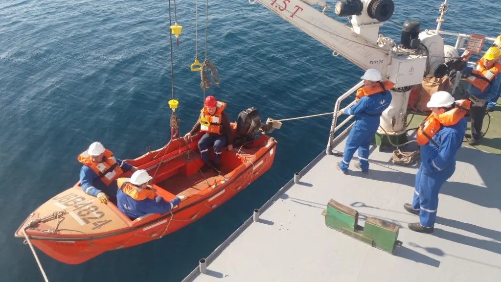 Crew members in life jackets during a rescue boat drill