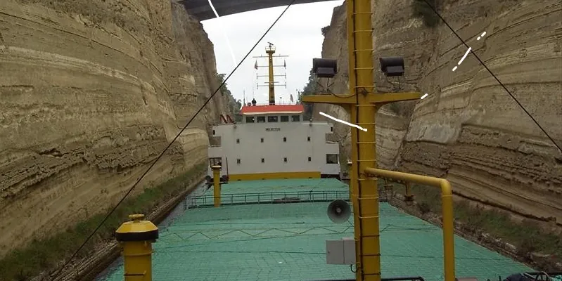 Lada 2005 transiting a narrow canal cut between steep rock walls
